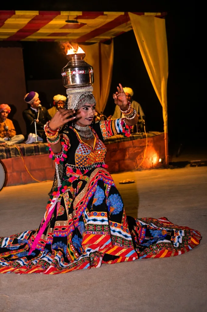 Rajasthani Chari folk dancer performing fire pot balancing in traditional embroidered costume