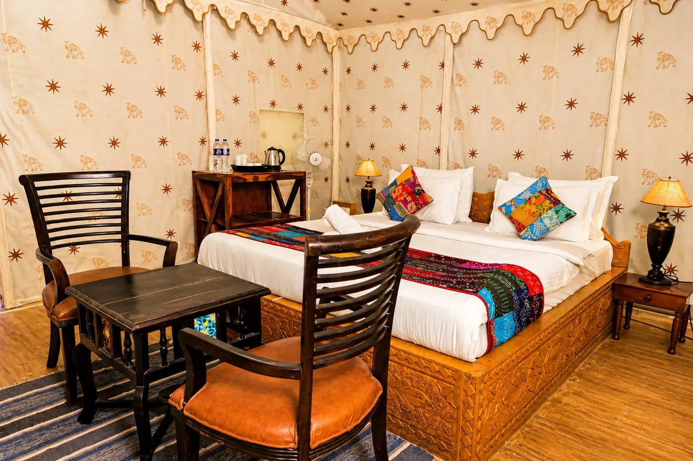Deluxe Tent sitting area with wooden chairs and table