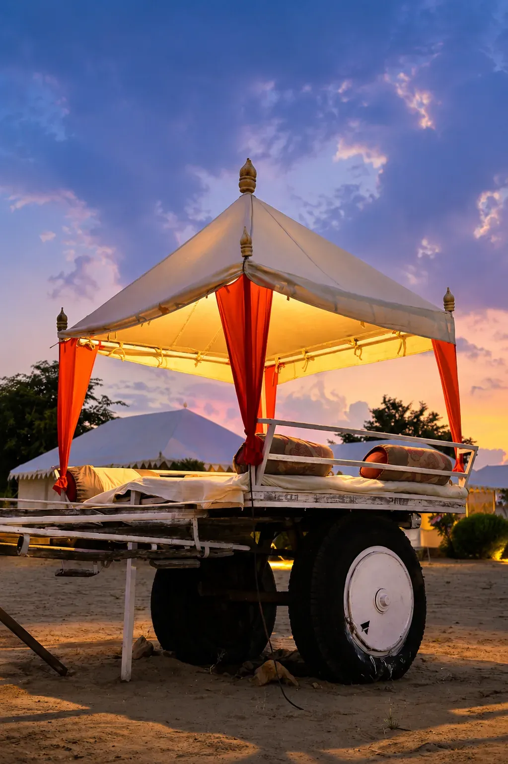 Intimate candlelit seating arrangement on sand dunes under night sky